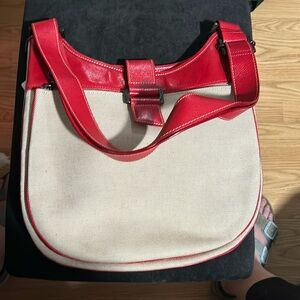 Red longchamps bag with canvas and pewter accessories.